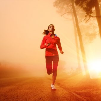 Athlete running on the road in morning sunrise training for mara
