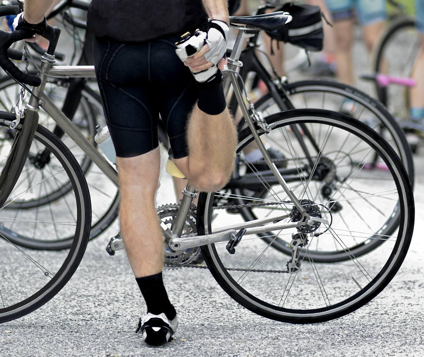 Man stretching his legs before a bicycle event.