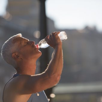 handsome senior jogging man drinking fresh water from bottle aft