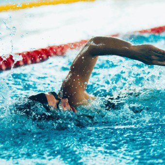 Freestyle swimming competitor in action, horizontal image