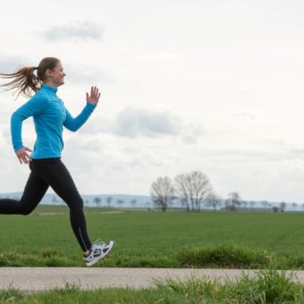 pretty young woman in blue jogging (running) outdoors