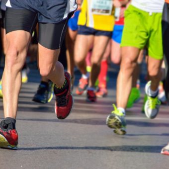 Marathon running race, runners feet on road