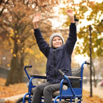 Little boy in wheelchair outdoors