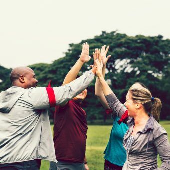 bigstock-Team-stacking-hands-before-a-r-243019606